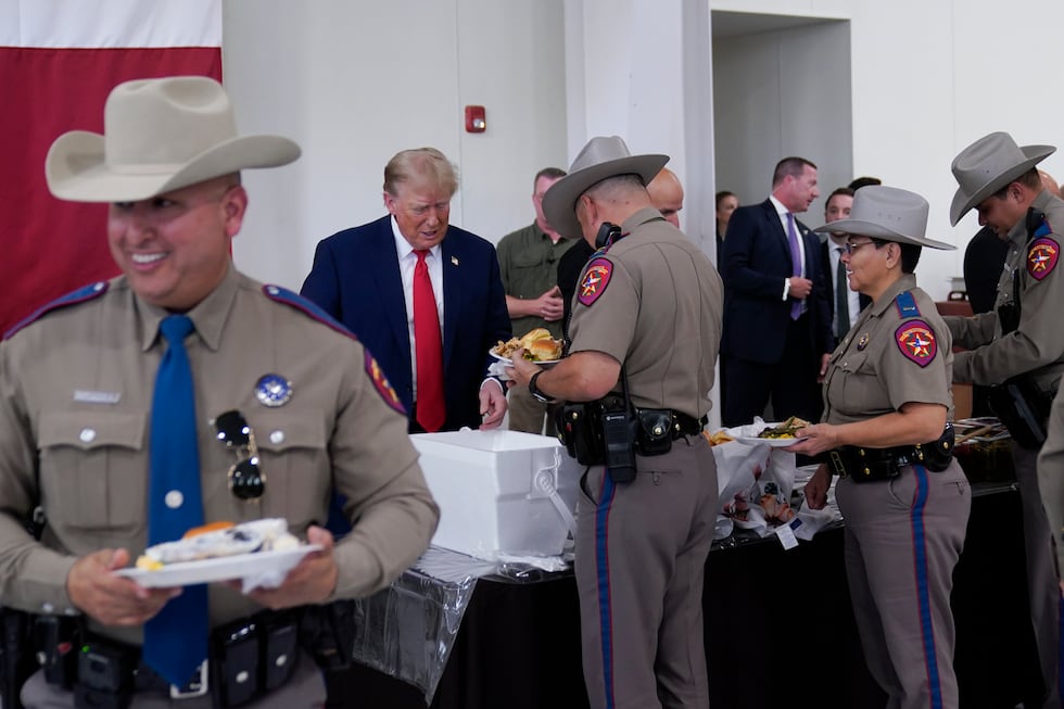 Republican presidential candidate and former President Donald Trump helps serve food to Texas...