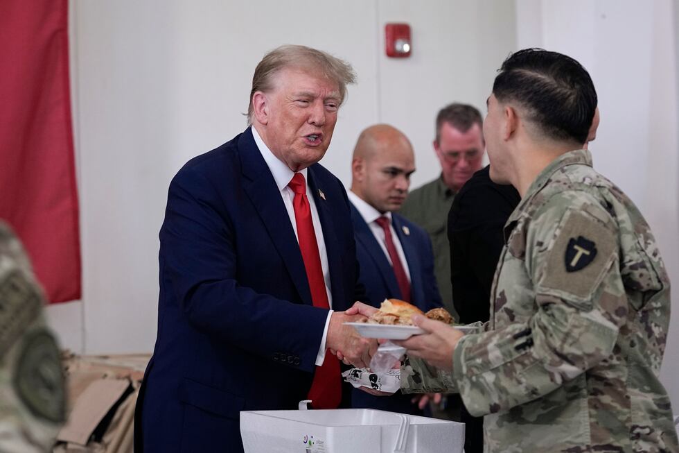 Republican presidential candidate and former President Donald Trump helps serve food to Texas...