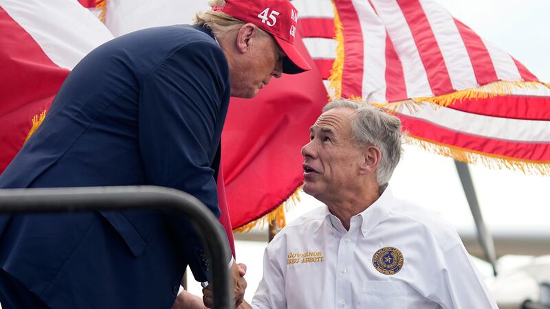 Republican presidential candidate and former President Donald Trump, left, shakes hands with...