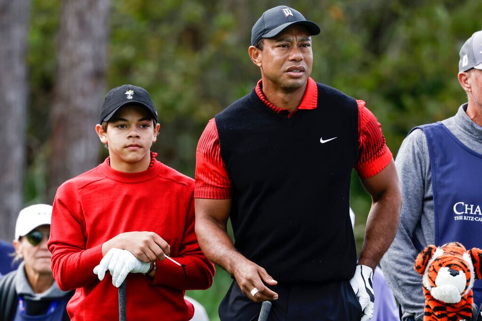 Tiger Woods, right, and his son Charlie Woods, left, prepare to tee off on the 3rd hole during...